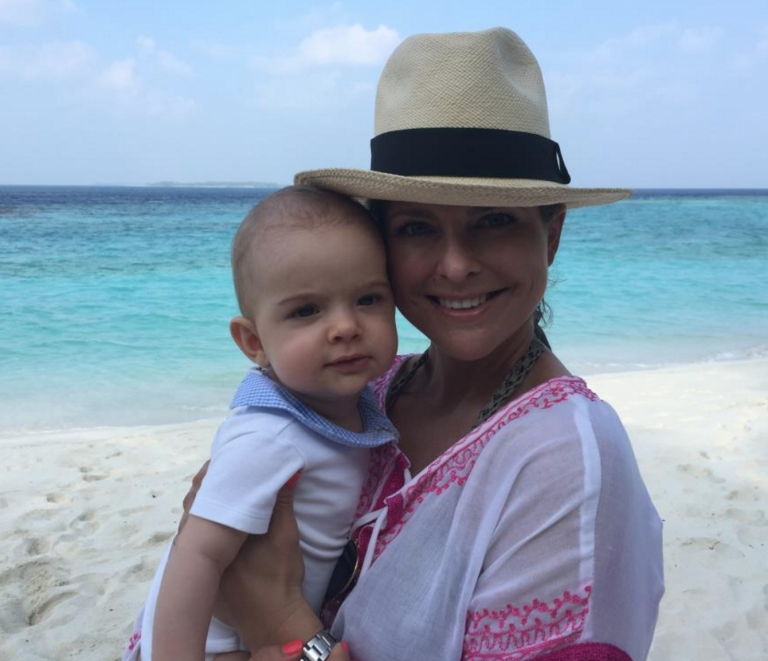 princess madeleine holds prince nicolas beach