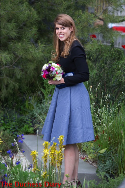 princess beatrice smiles holds flowers chelsea flower show press day