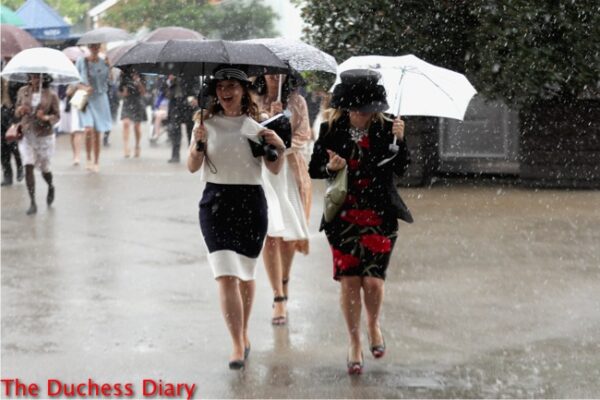 ladies laugh run for cover umbrellas royal ascot day one